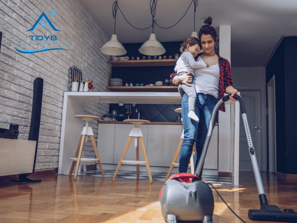 Mother holding infant while vacuuming carpet to reduce allergens